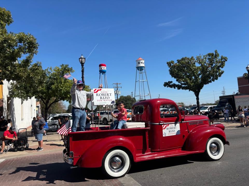 Robert Rizo participating in a parade with his red 1941 Chevrolet